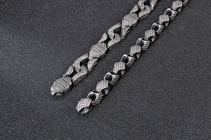Macro shot of vintage silver men's bracelets with tribal engraving and scale texture