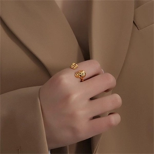 Close-up of gold skull open ring in S925 sterling silver worn on a finger