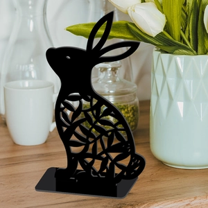 Detail of black hollow acrylic Easter bunny ornament with floral leaf patterns on base