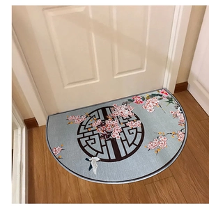 Detail of semi-circular door mat with Chinese floral pattern on wooden floor