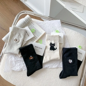 Detail of four pairs of breathable mid-calf socks with cute animal embroidery and dot yarn