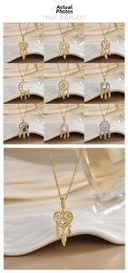 Macro view of bohemian dreamcatcher and heart pendants with zircon inlay on gold plating