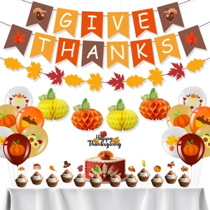 Detailed set of Thanksgiving party decorations with Give Thanks banner and paper pumpkins