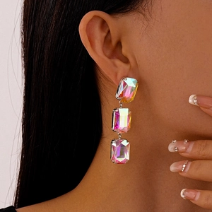 Macro shot of silver drop earrings with three layered iridescent rectangular crystals
