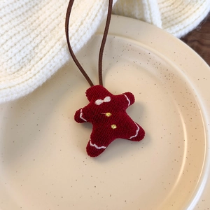 Detail of red star gingerbread man pendant on a ceramic plate with warm holiday vibes