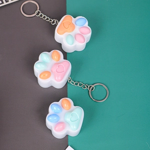 Detail view of heart-shaped cat paw silicone keychain pendants in macaron colors
