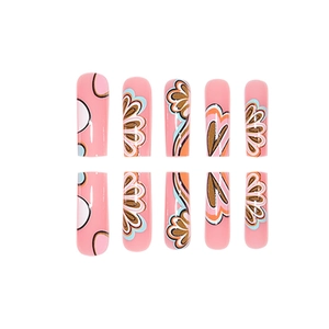 Pink press-on nails with floral doodle patterns and gold accents on 24pc long pipe shape