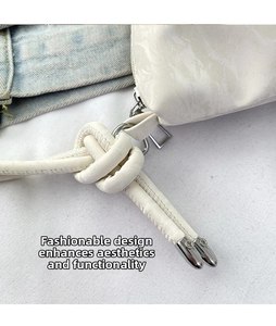 Detail of the stylish white shoulder bag showing the knotted strap and silver hardware