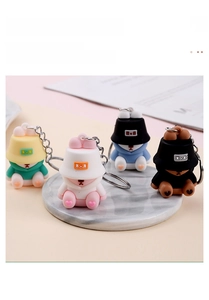 Close-up of four colorful PVC bear keychains with hoodies and fisherman hats