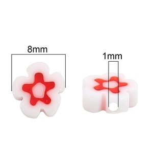 Detailed view of 8mm plum blossom glass bead with white petals and red star center