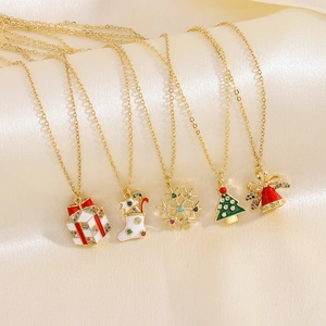 Detail showing five Christmas necklaces with enamel pendants on a silk background