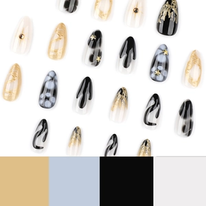 Black marble almond press-on nails with gold foil accents and 3D star metallic studs