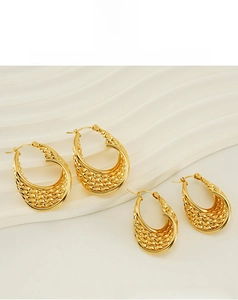 Detailed view of gold mesh textured oval hoop earrings in two sizes on white background