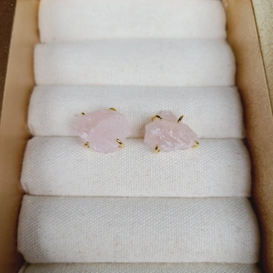 Pink natural stone earrings with four-prong gold setting in a jewelry box