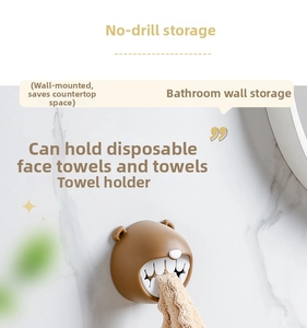 Brown bear towel holder wall-mounted on white marble tile for bathroom organization