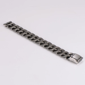 Macro detail of 19mm chunky steel bracelet with textured snake scale patterns