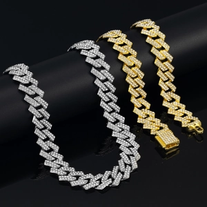 Close-up of high-quality gold and silver Cuban link chains with shimmering rhinestones