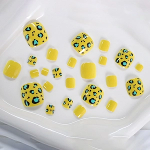 Short square press-on toenails featuring yellow and blue leopard print patterns