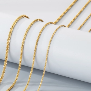 Polished gold stainless steel rope chains in various thicknesses on white background