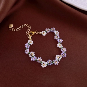 Handmade purple and white floral beaded necklace with gold heart charm and extension chain