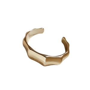 Minimalist gold wavy acrylic open bangle bracelet with a modern architectural dragon bone design