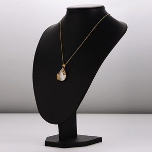 Elegant gold stainless steel necklace with water drop cat eye stone on a black bust display