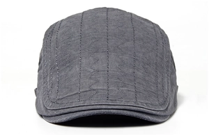 Detailed view of dark grey flat cap with unique vertical wave stitching and fabric texture