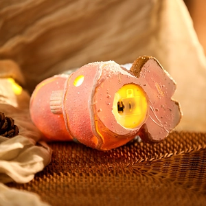 Macro detail of Christmas figurine base showing battery compartment and power switch