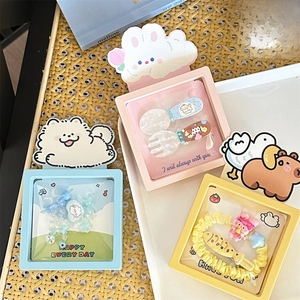 Detailed view of colorful cartoon-themed hair accessory sets in pastel display gift boxes