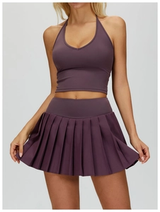 Detail view of purple high-waisted pleated tennis skirt and halter neck sports vest set