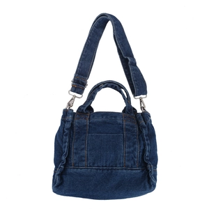 Deep blue denim canvas shoulder bag with dual handles and adjustable strap on white background