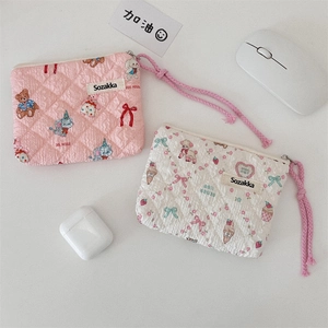 Detailed macro view of quilted floral storage bags with cute animal prints and zipper