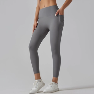 Detail view of high-waisted gray yoga pants showing seamless side pockets and smooth fabric