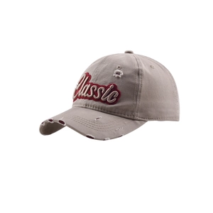 Detail showing distressed holes and red Classic 3D embroidery on the khaki baseball cap