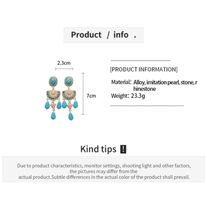 Detailed view of vintage drop earrings with turquoise stones and dimensions 7cm by 2.3cm