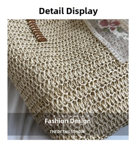 Detailed close-up of woven straw bucket bag with white floral lace and leather strap details