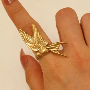 Macro view of gold flying bird open ring with detailed feather texture for women