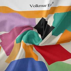 Detailed macro view of silky colorful geometric pattern fabric with Volkmar Ess text