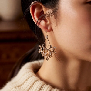 Detail of 18k gold plated drop fringe earrings with sparkling zircon on a model