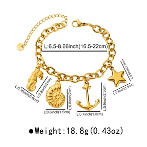 Detailed view of ocean theme charms on a gold stainless steel link bracelet with dimensions