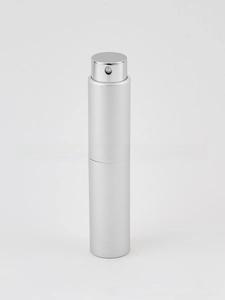 Close-up of a silver aluminum perfume atomizer with a matte finish and a press nozzle