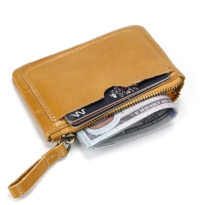 Detail of crazy horse leather coin pouch featuring external card slot and zipper closure