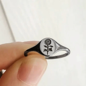 Minimalist silver sunflower signet ring with engraved floral oval face for men and women