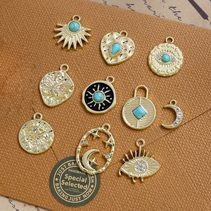 Set of 10 vintage gold alloy sun and eye pendants with turquoise and rhinestones