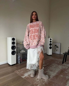 Relaxed fit pink floral knit sweater styled with lace skirt and suede boots