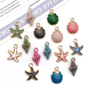 Flat lay of colorful enamel sea shell star and conch alloy charms for DIY jewelry making