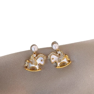 Elegant gold plated rocking horse earrings with pearls and white shell inlay details