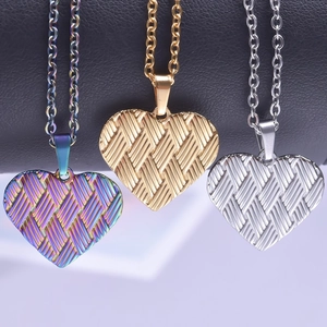Three textured heart pendants in rainbow, gold and silver on stainless steel link chains