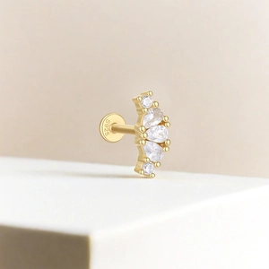 Macro shot of S925 sterling silver gold stud earring with teardrop cubic zirconia stones