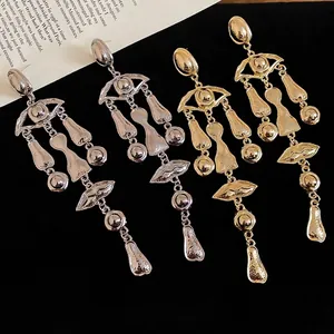 Abstract retro tassel drop earrings with hammered metal eye and lip charms in gold and silver